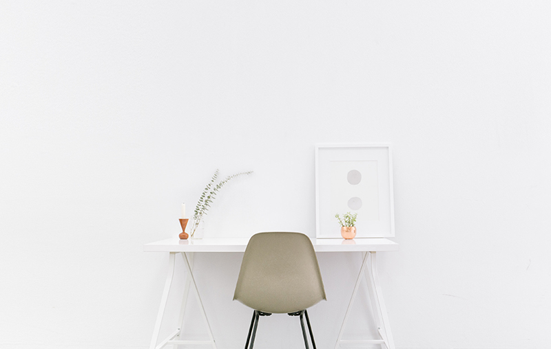 a chair white chair at a white desk on a white wall